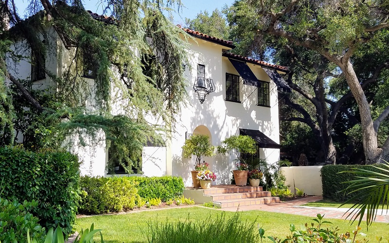 Mediterranean home with landscaped curb appeal