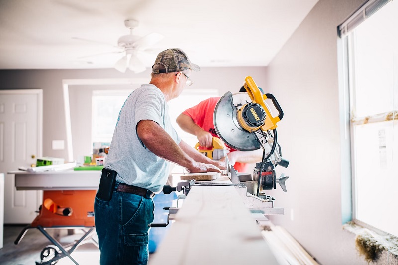 Professional contractors working on a renovation project in the main living room of a home