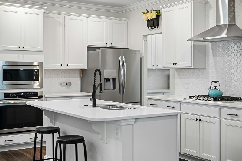 Compact white kitchen with two overlapping work triangles