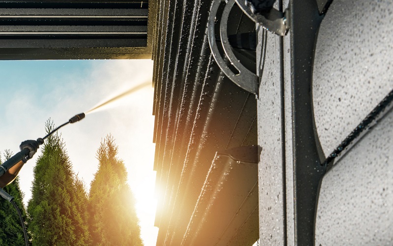 Close up view of an aluminum carport being power washed with the right pressure and distance