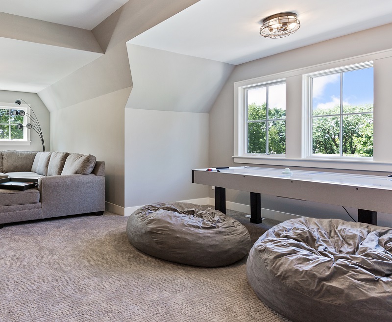 Large recreation game room with comfortable seating, including bean bag chairs