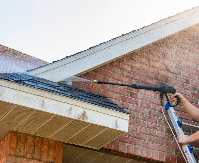Power washing brick siding and roof with proper pressure and distance