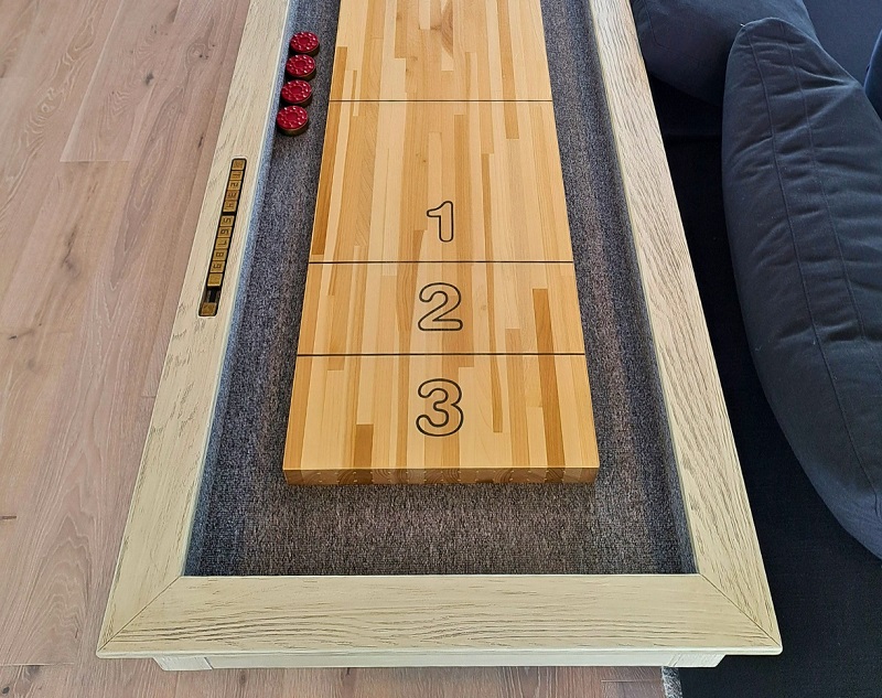 Shuffleboard and comfortable sofa in rec room