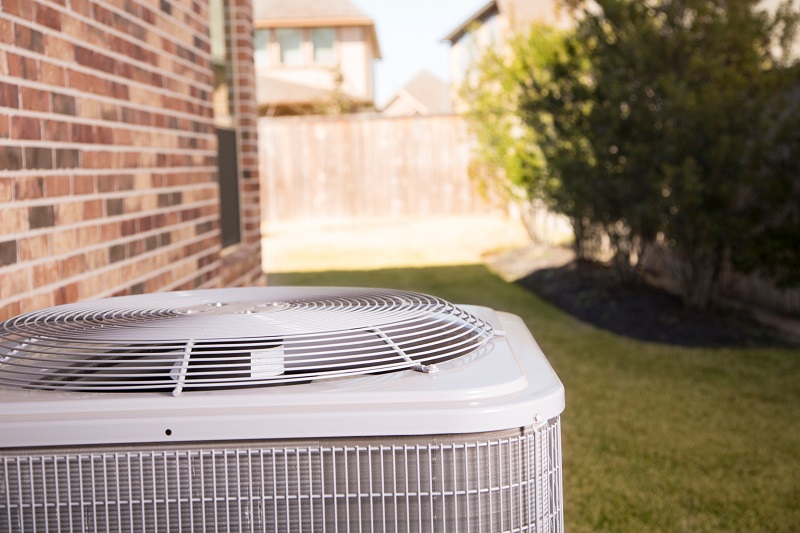 Top portion of an outdoor AC condenser during the summer