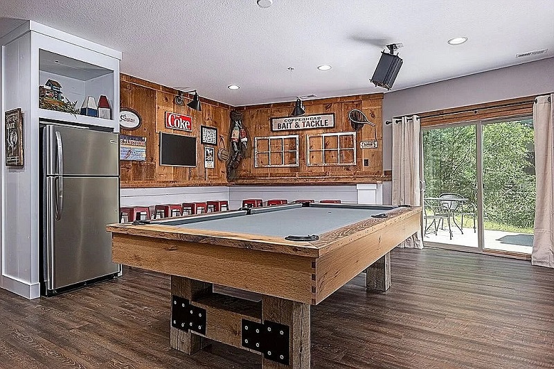 Large rec room with refrigerator, billiard table and ample counter stools