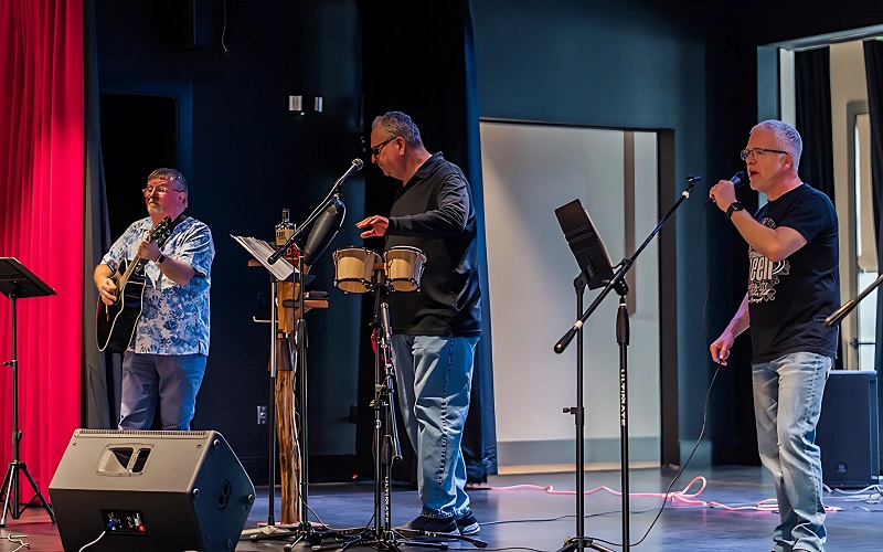 A trio of residents giving a musical performance at the Community Hall at Amblebrook