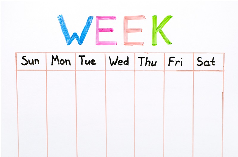 A child's weekly activity calendar on a whiteboard