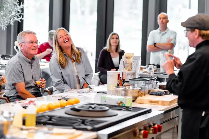Residents enjoying a cooking class being held in the Demonstration Kitchen at Amblebrook