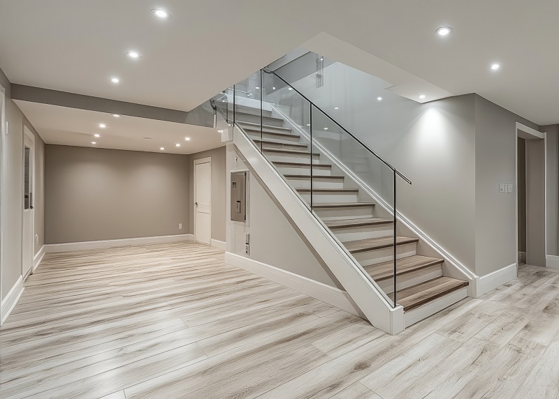 Empty, pristine renovated modern basement with new drywall