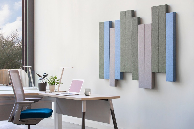 a large sunny home office with creative acoustic panels on the wall