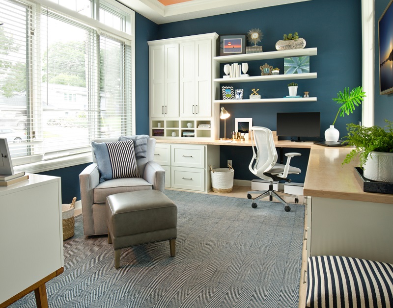 Large blue home office with natural light, house plants, and space to be organized