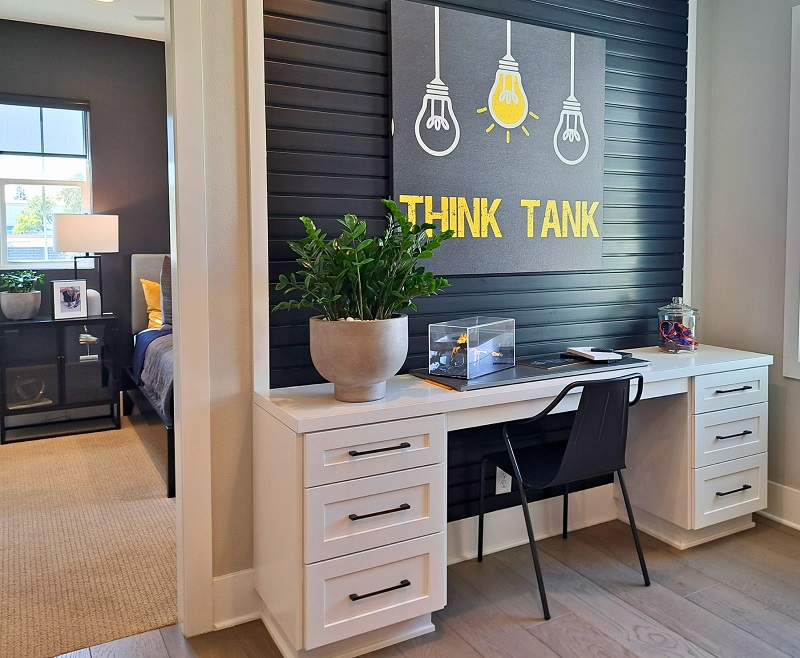 Minimalist decluttered workspace with white desk and yellow highlighted print
