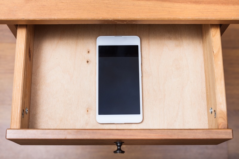 Mobile phone being stored away in drawer to improve productivity
