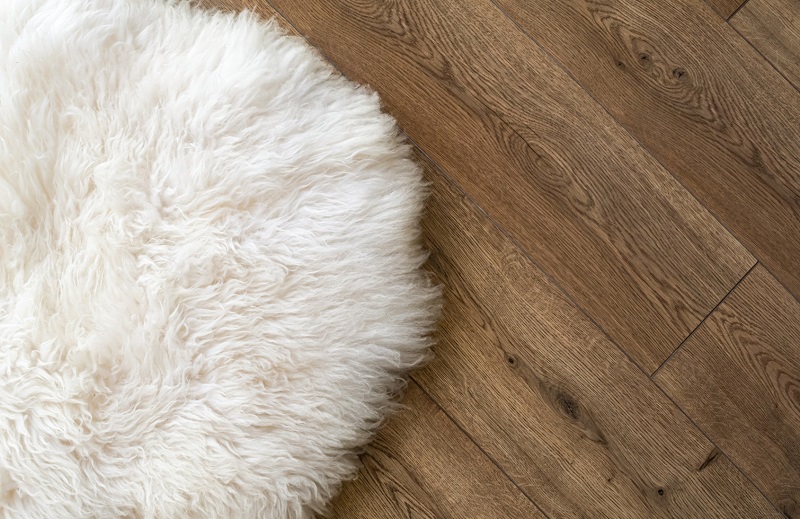 Sheep skin rug on LVP flooring in basement