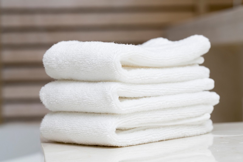 Soft folded towels in a peaceful luxury spa setting