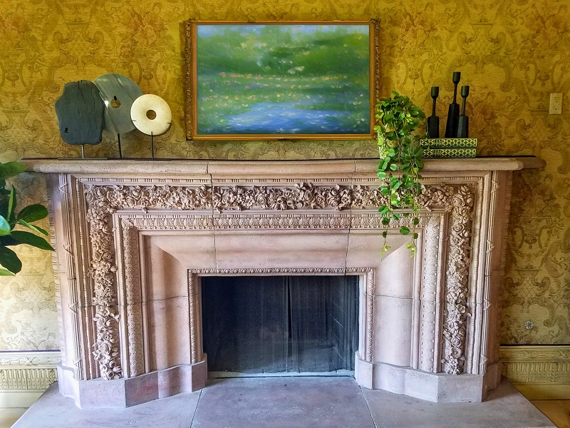 Ornate stone mantel fireplace in family room