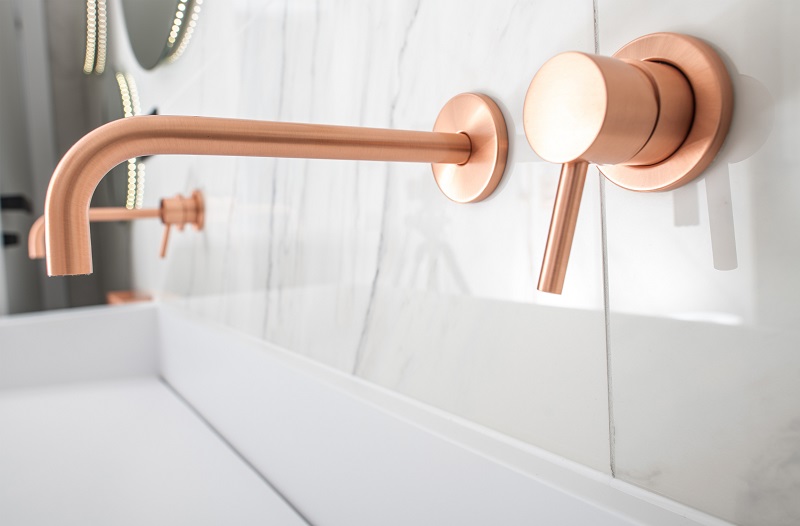 Lavish white sink with striking copper fixtures