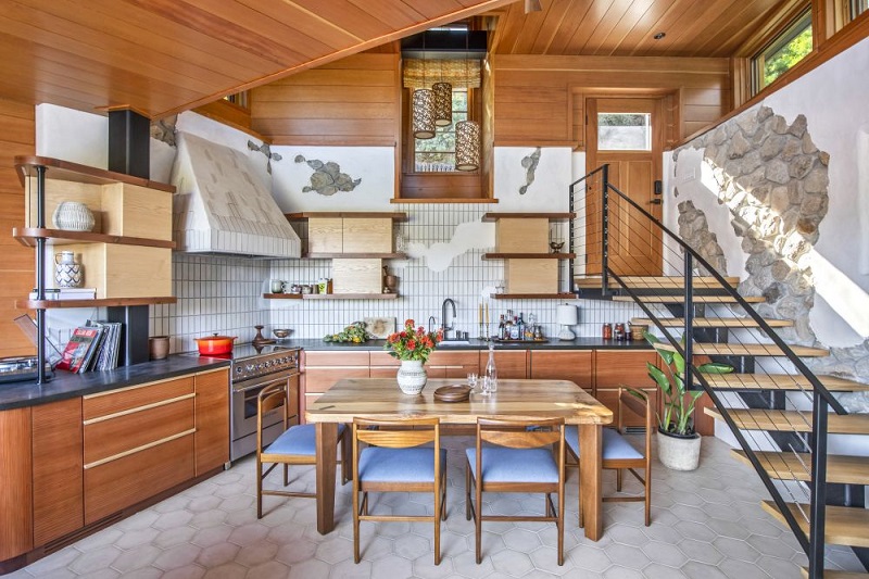 A view of the front entrance and kitchen and curved stairway. Photo by Christopher Nolasco
