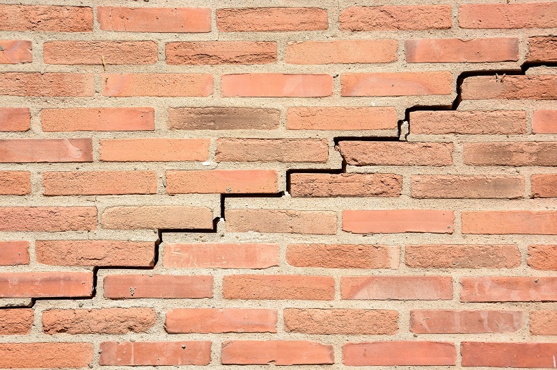 Brick wall with severe stair step cracks
