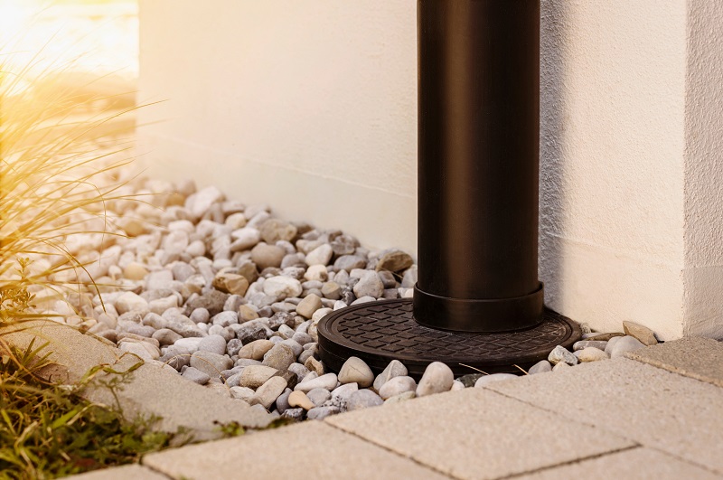 Rain downspout that connects to a French drain that runs water away from the foundation underground