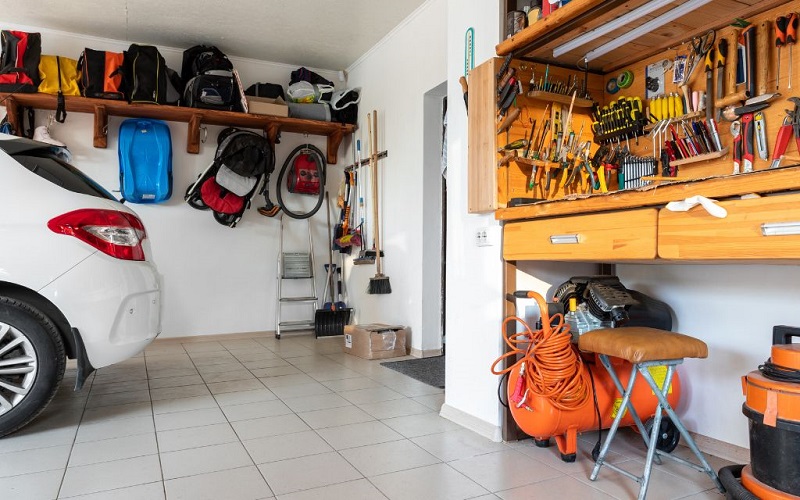 Residential garage with hanging camping gear, well-kept work bench and large tools out of the way