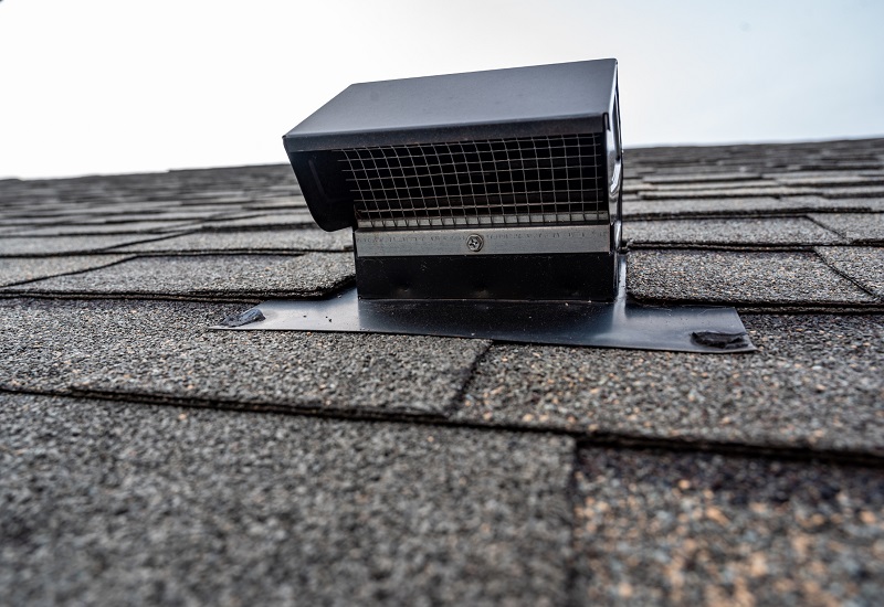 View of a static vent installed on a shingle roof for passive attic ventilation