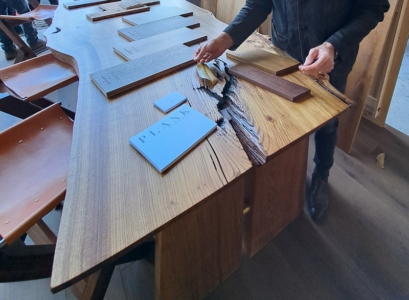 Plank Hardwoods' bespoke dining table and leather stools featured at WestEdge Design Fair 2025