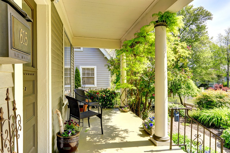 Large porch with chairs accented with classic columns