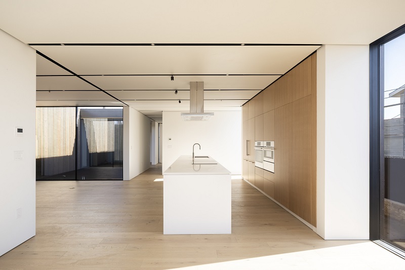 The integrated kitchen connected to dining and living room spaces in Sue Labella's home by Cover