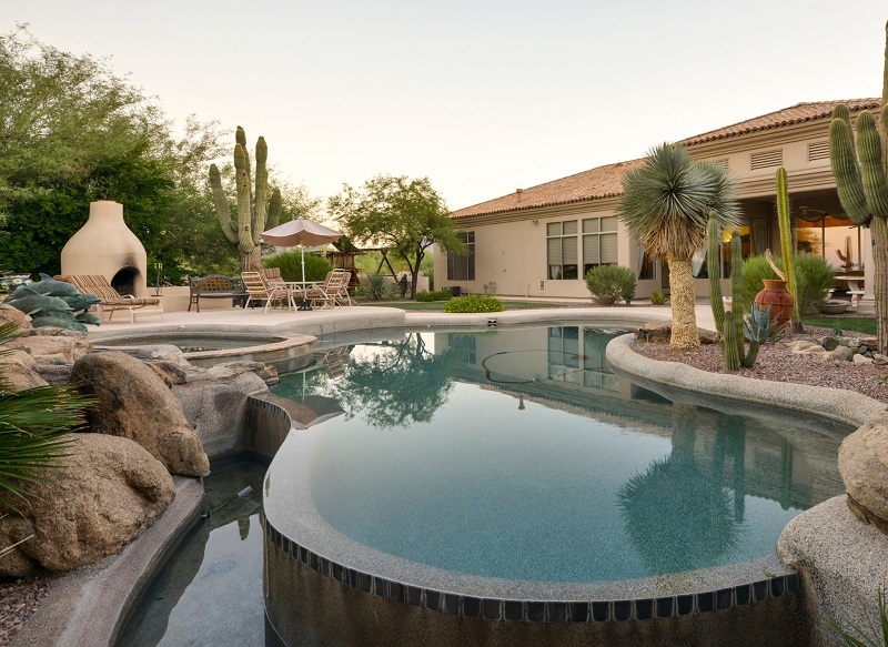 Desert home with an unconventional backyard swimming pool