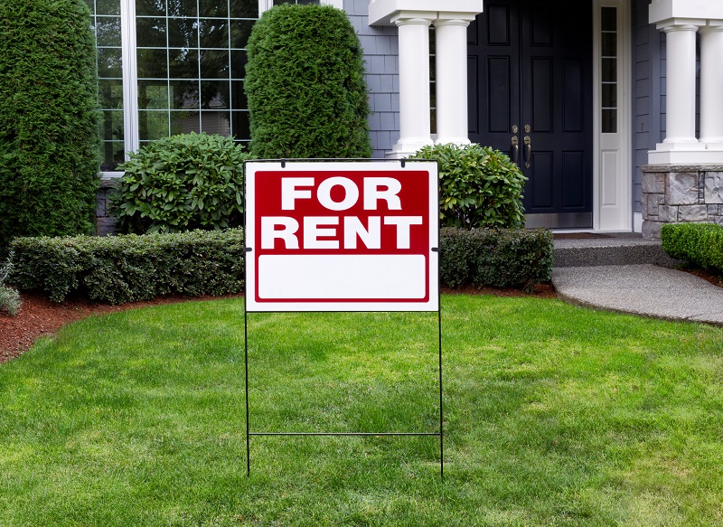 Large single family home with prominent For Rent sign in front yard