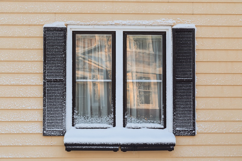 Black trim winter windows with snow