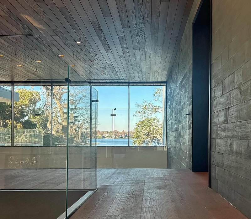 TNAH 2026 Universal Design elements: wide hallways, with biophilic wood floors, paneling, natural lighting, and scenic water views. Photo by Michael Wenrich Architects