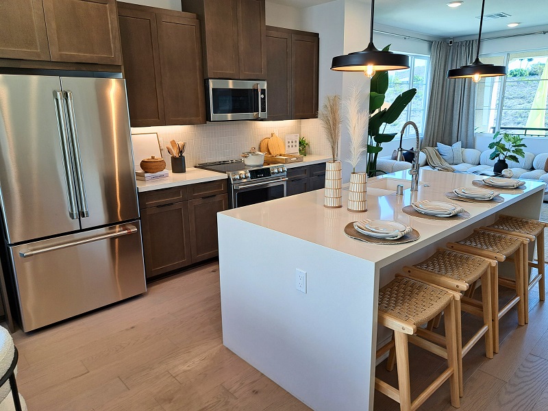 Warm Bobby Berk designed kitchen in a Tri Pointe Homes model home in San Diego, California