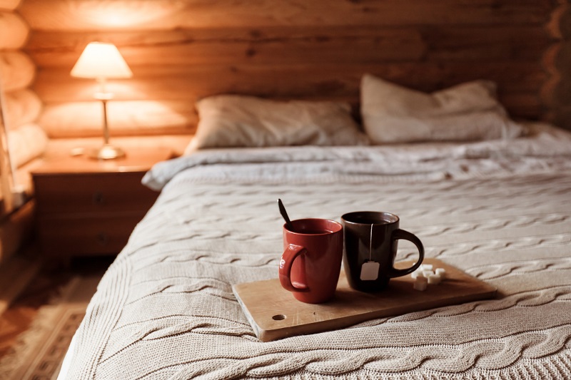 Cozy log cabin bedroom with quality mattress and bedding