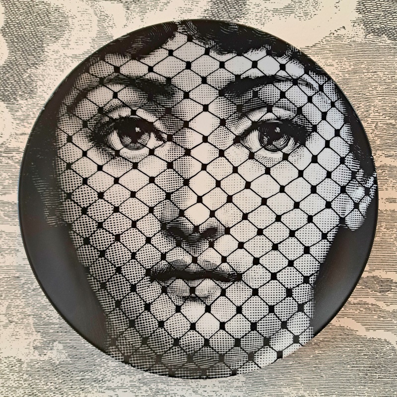 Close up view of a Fornasetti Lina Cavalieri plate on display at the Ricca Design Los Angeles showroom