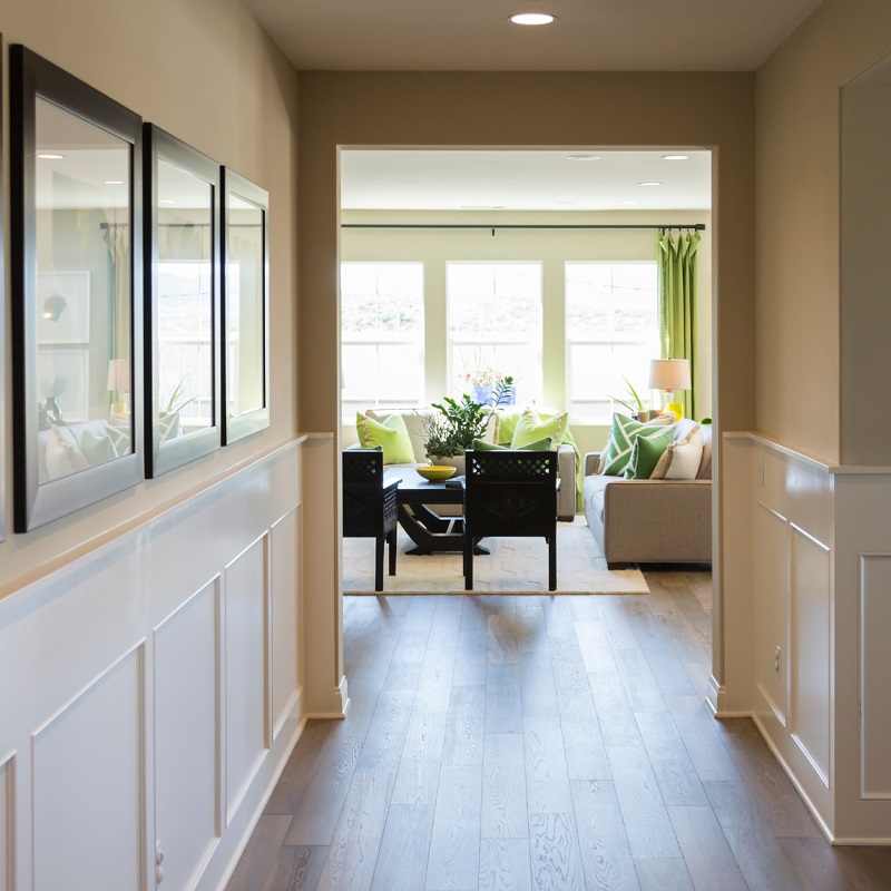 Home with wide entrance hallway to open concept floor plan
