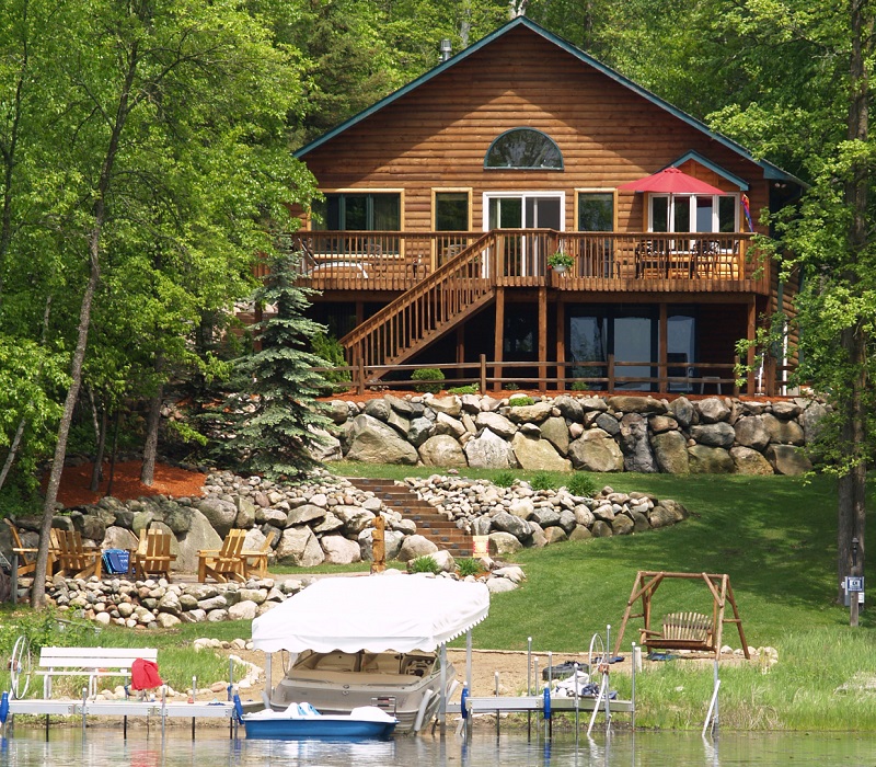 Lakefront log cabin home with landscaped shoreline