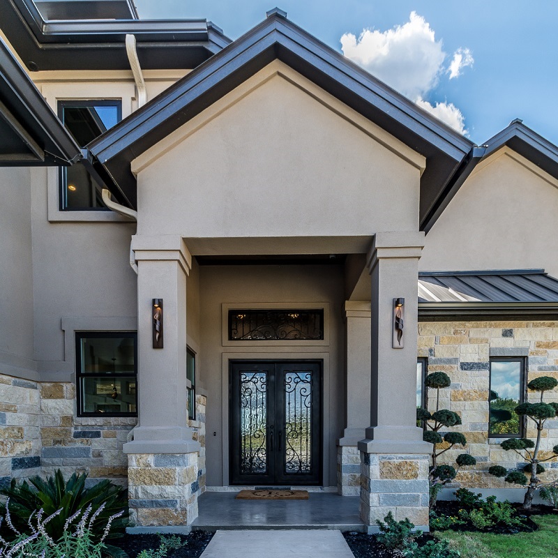 Newly built resilient stucco and stone home with low threshold entrance