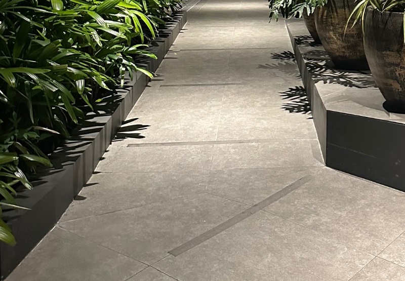 A non-slip, well-lit, wheel chair accessible walkway at night