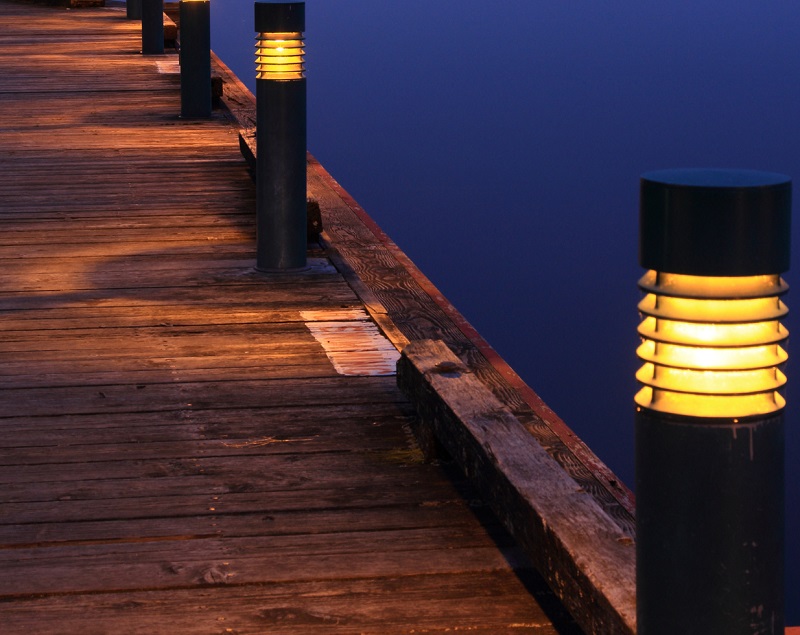private wooden pier with landscape lighting