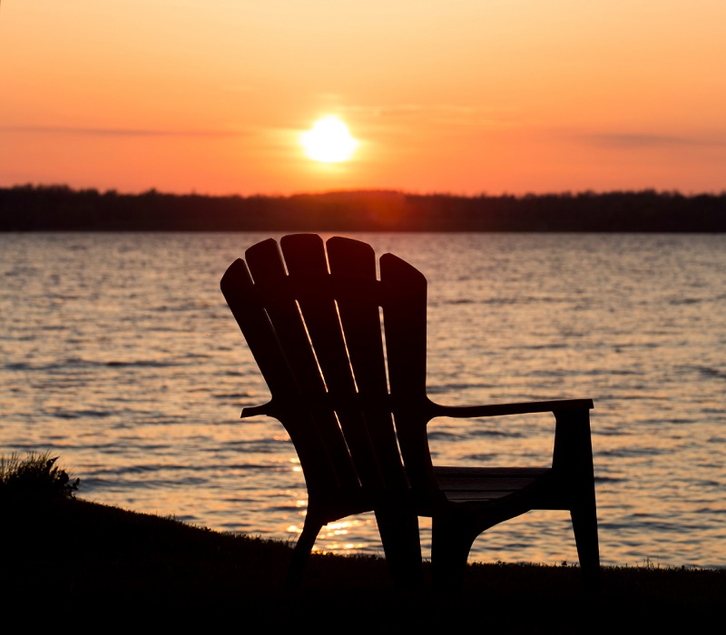 View of sunset over lake from a cabin property