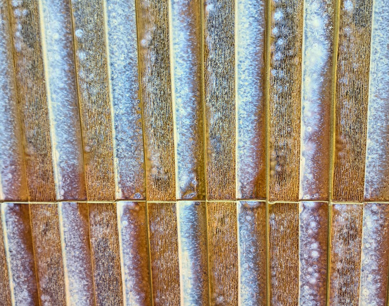 Long articulated tile with patina exhibited by Natucer at Coverings 2026