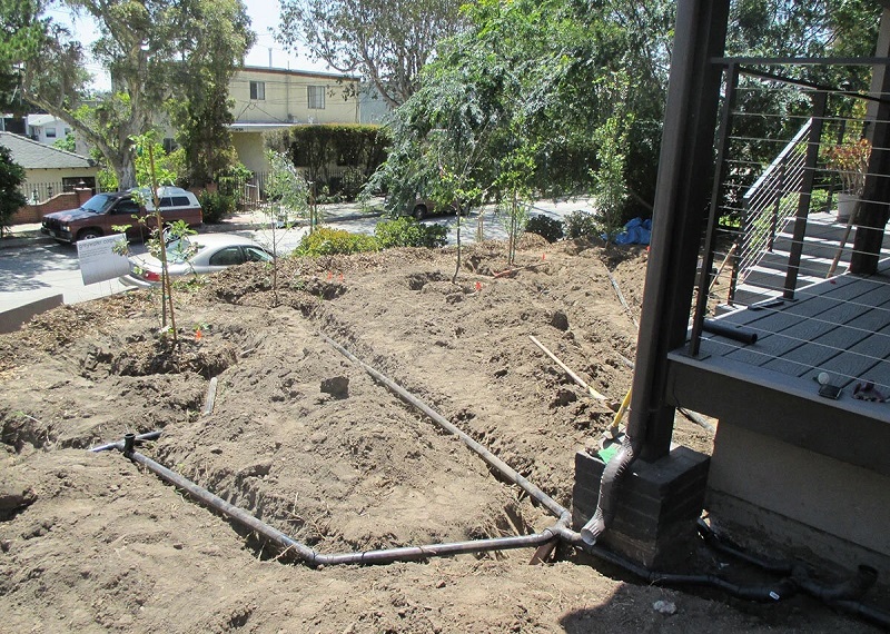 Branched drain installation in the front yard of a construction site