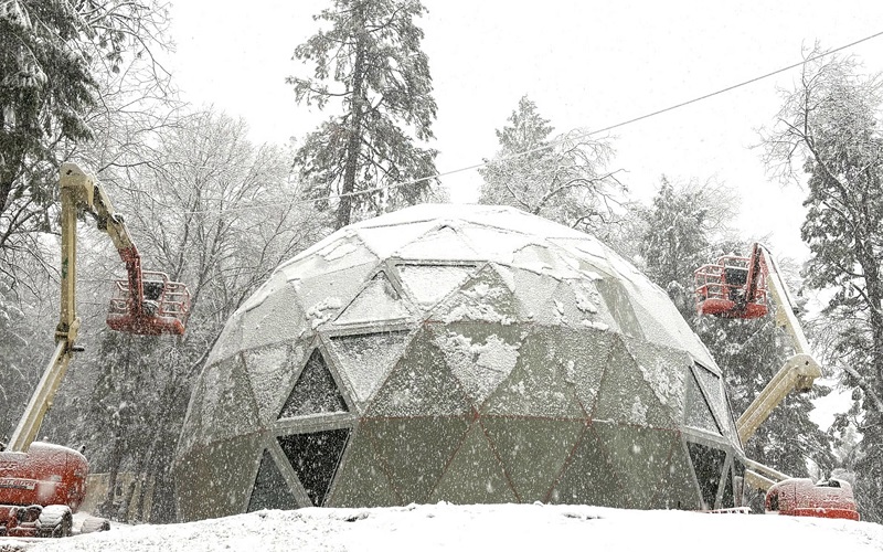 Geoship's first Amma home being assembled during a snowstorm in Northern California