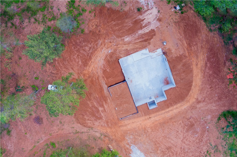 Aerial view of a concrete foundation of a rural home under construction