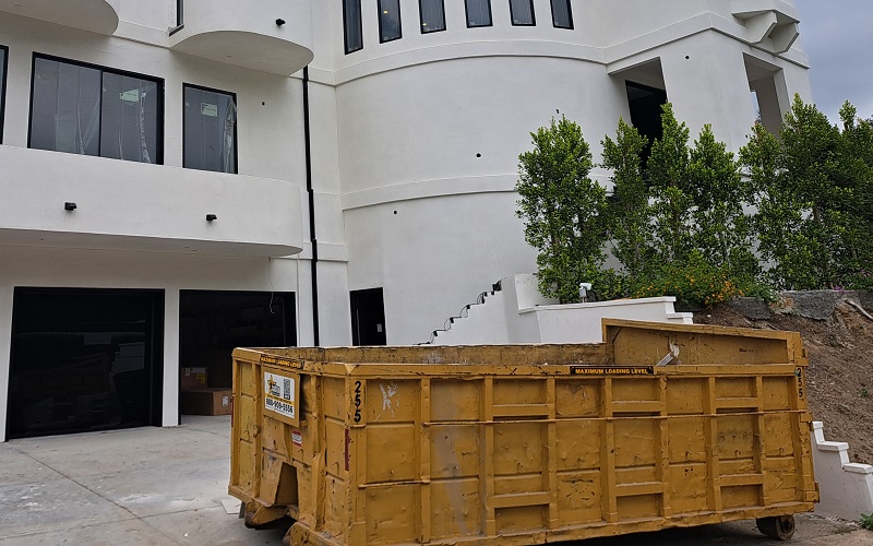 Home undergoing whole renovation directing contractor traffic through the garage, away from newly planted bushes